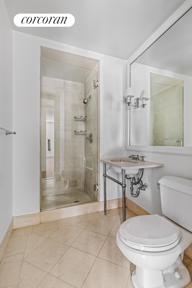 400 E 51st St Unit 4E, New York City, NY 10022 - bathroom featuring toilet, a shower stall, tile patterned floors, and baseboards