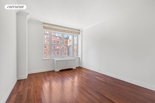 400 E 51st St Unit 4E, New York City, NY 10022 - empty room featuring ornamental molding, wood finished floors, and baseboards