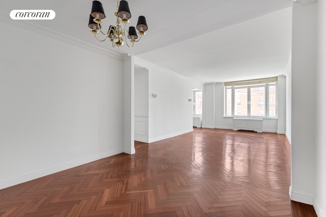 400 E 51st St Unit 4E, New York City, NY 10022 - empty room with a chandelier, crown molding, and baseboards
