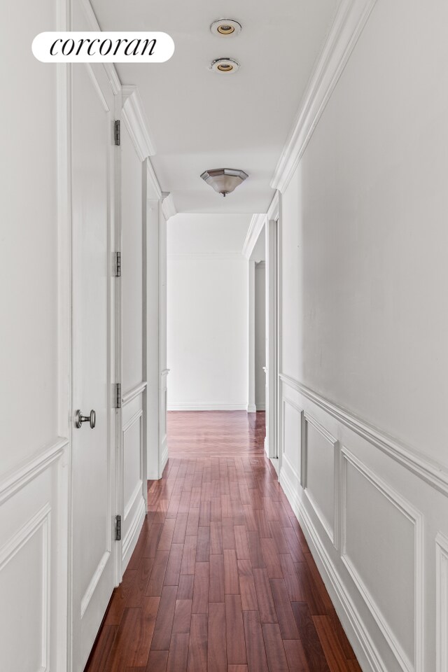 400 E 51st St Unit 4E, New York City, NY 10022 - corridor featuring dark wood-style floors, a decorative wall, and wainscoting