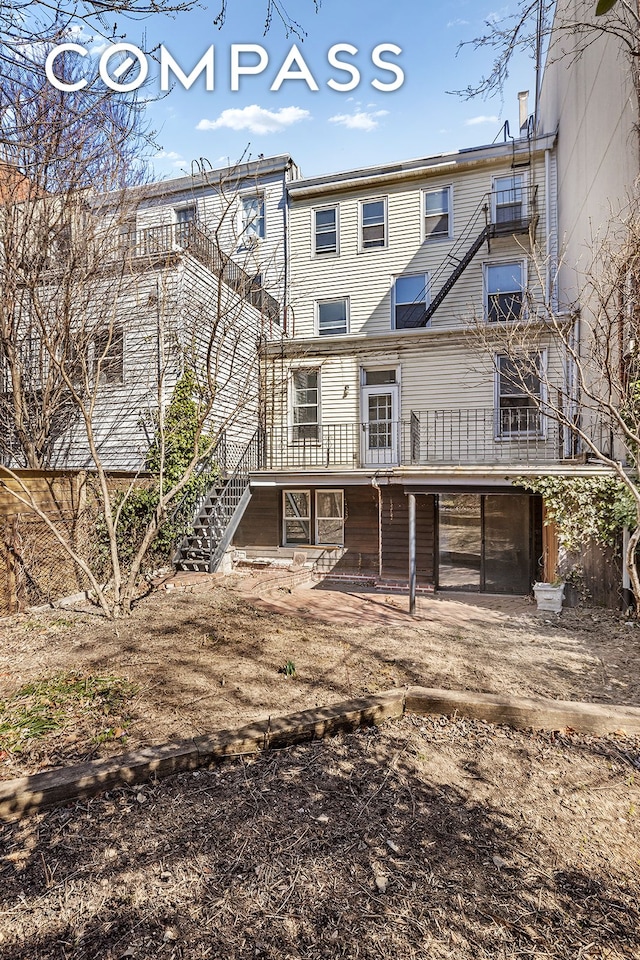 rear view of property featuring stairs