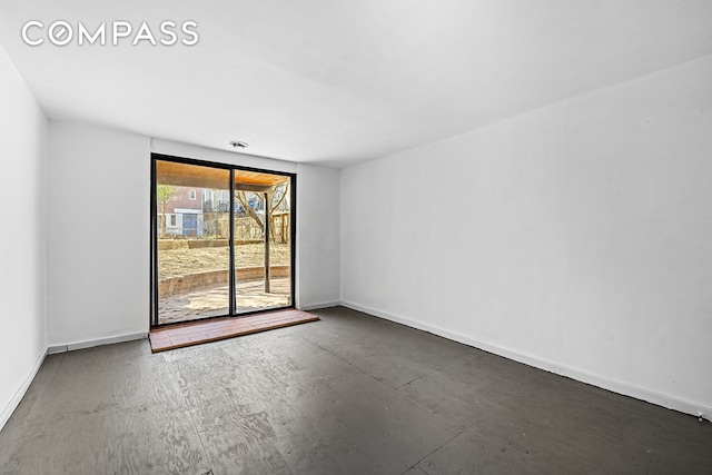 empty room featuring baseboards