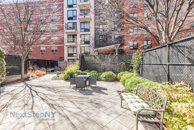 view of patio featuring outdoor dining space and a fenced backyard