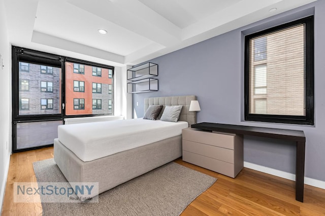 bedroom with light wood-type flooring, baseboards, and recessed lighting