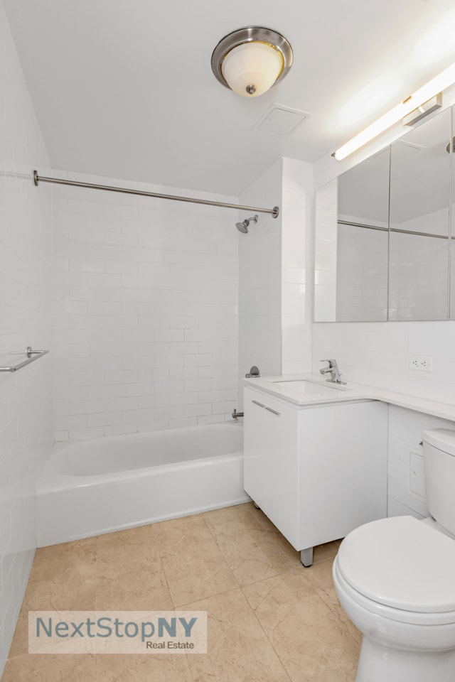 full bath featuring toilet, washtub / shower combination, and vanity