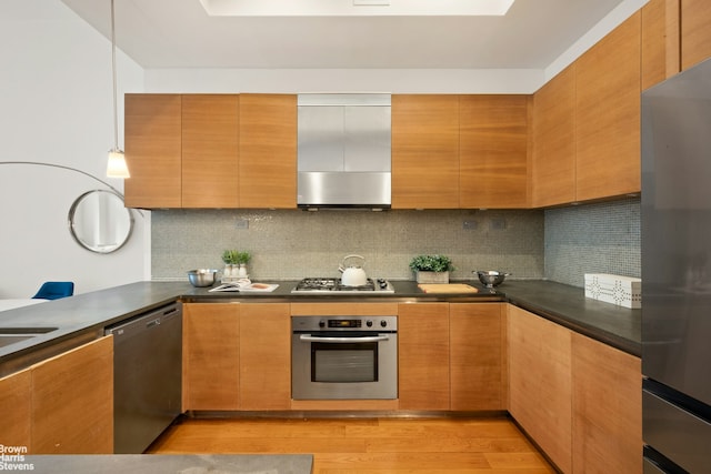 49 E 21st St Unit 2B, New York City, NY 10010 - kitchen with stainless steel appliances, dark countertops, light wood-type flooring, and backsplash