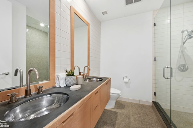 49 E 21st St Unit 2B, New York City, NY 10010 - bathroom featuring toilet, a stall shower, and double vanity