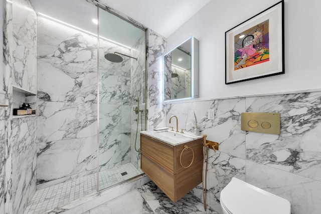 full bath featuring vanity, marble finish floor, toilet, tile walls, and a marble finish shower