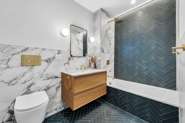 bathroom with tiled shower / bath combo, tile walls, toilet, and vanity
