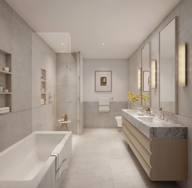 bathroom with a garden tub, toilet, a sink, tile walls, and a stall shower