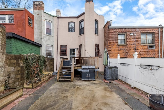 view of patio / terrace with area for grilling and fence