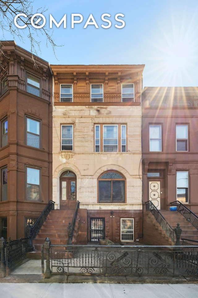 660 Macon St, New York City, NY 11233 - view of property featuring a fenced front yard