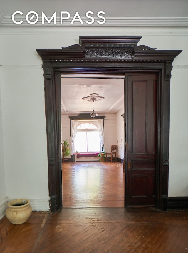 660 Macon St, New York City, NY 11233 - hallway with dark wood finished floors and ornamental molding