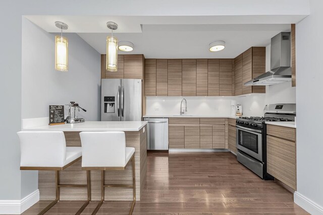 333 E 34th St Unit 2M, New York City, NY 10016 - kitchen with appliances with stainless steel finishes, wall chimney exhaust hood, a breakfast bar, a sink, and light countertops
