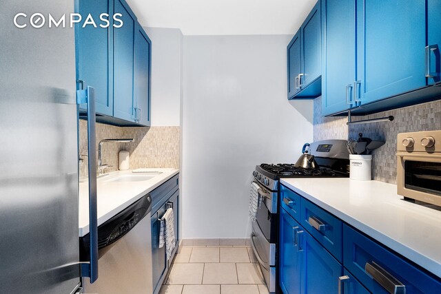 333 E 14th St Unit 10D, New York City, NY 10003 - kitchen featuring stainless steel appliances, blue cabinets, a sink, and backsplash