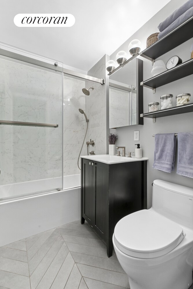 433 W 34th St Unit 6F, New York City, NY 10001 - full bath with toilet, combined bath / shower with glass door, and vanity