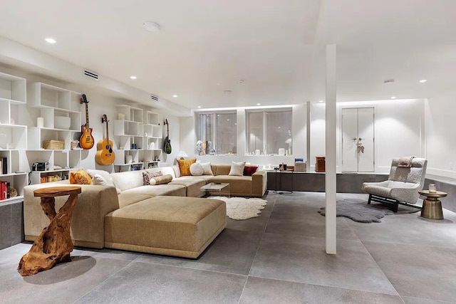 living area with visible vents, recessed lighting, and concrete floors