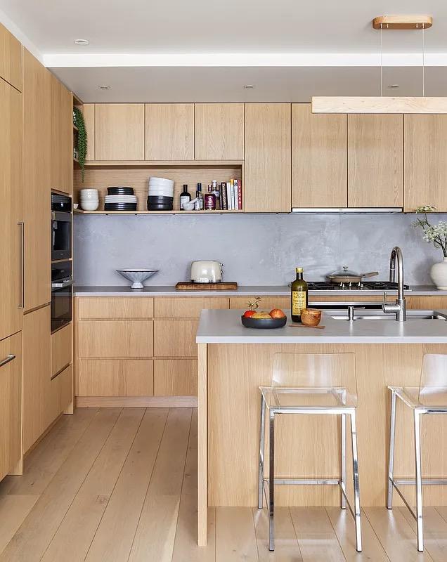 kitchen with modern cabinets, light brown cabinetry, open shelves, and a sink