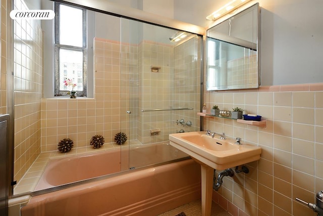 full bathroom featuring tile walls and shower / bath combination