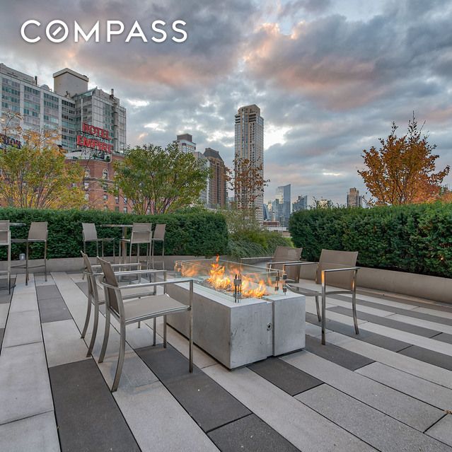 20 W 64th St Unit 41H, New York City, NY 10023 - patio terrace at dusk with an outdoor fire pit, a view of city, and a patio