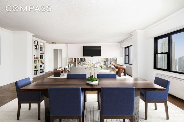 20 W 64th St Unit 41H, New York City, NY 10023 - dining room with a textured ceiling, crown molding, and wood finished floors