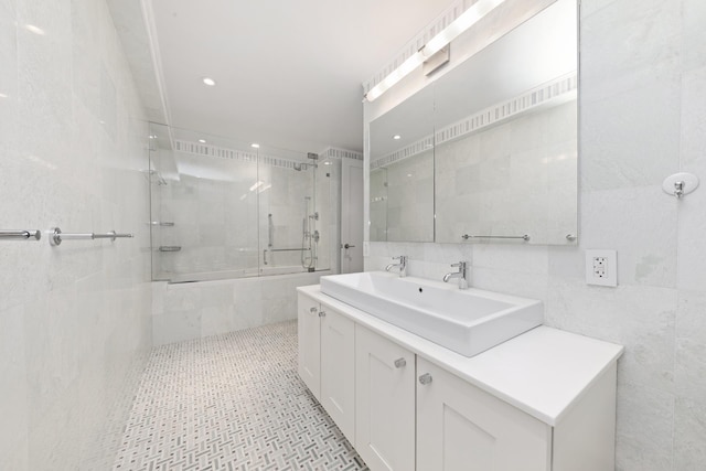 full bath with recessed lighting, vanity, and tile walls