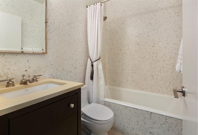full bathroom with tiled shower / bath combo, toilet, tile walls, and vanity