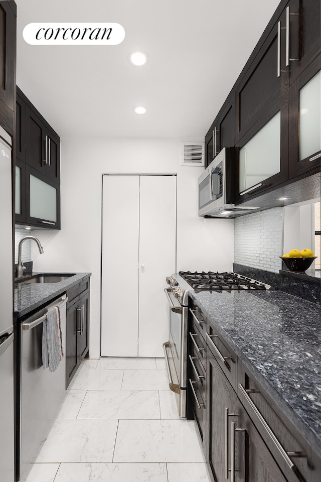 4 W 109th St Unit 2F, New York City, NY 10025 - kitchen with a sink, stainless steel appliances, light marble finish floors, recessed lighting, and dark stone counters