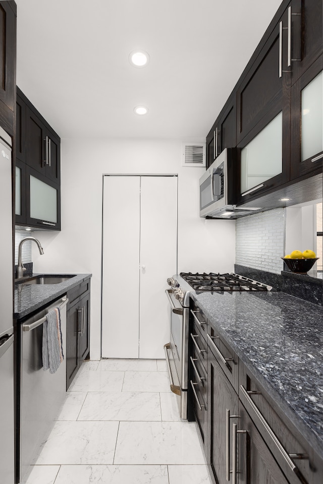 4 W 109th St Unit 2F, New York City, NY 10025 - kitchen featuring a sink, stainless steel appliances, light marble finish flooring, recessed lighting, and dark stone countertops