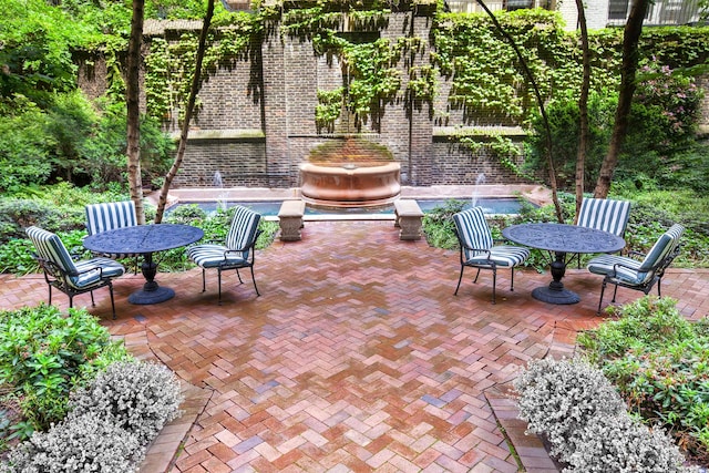 view of patio / terrace featuring outdoor dining space and a pool