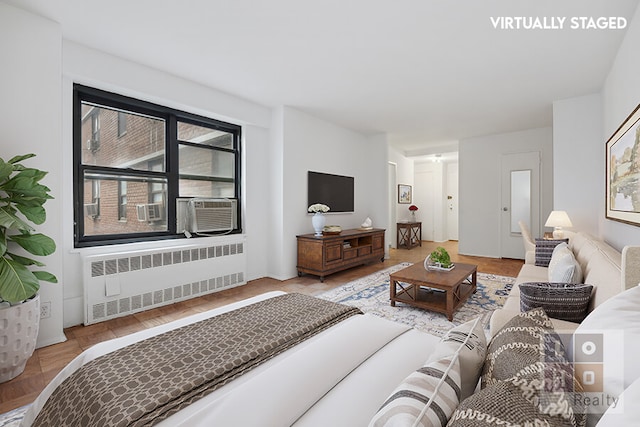 living room featuring radiator heating unit and cooling unit
