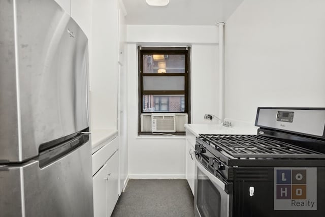 kitchen with baseboards, light countertops, cooling unit, white cabinets, and stainless steel appliances