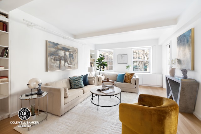living area featuring wood finished floors and built in features