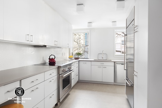 51 5th Ave Unit 2Bf, New York City, NY 10003 - kitchen featuring stainless steel appliances, a sink, backsplash, under cabinet range hood, and light flooring