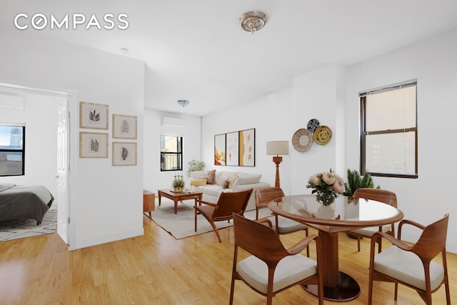 34-57 9th St, New York City, NY 11106 - dining space with light wood finished floors, plenty of natural light, and an AC wall unit
