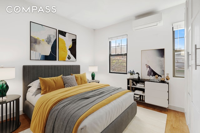 34-57 9th St, New York City, NY 11106 - bedroom with a wall unit AC and wood finished floors