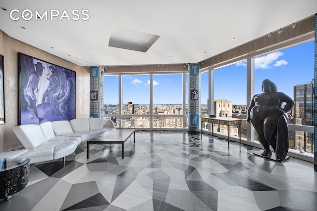 living area with floor to ceiling windows and a city view