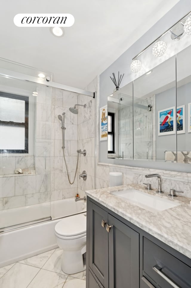 211 E 35th St Unit 4D, New York City, NY 10016 - bathroom featuring marble finish flooring, vanity, bath / shower combo with glass door, and toilet