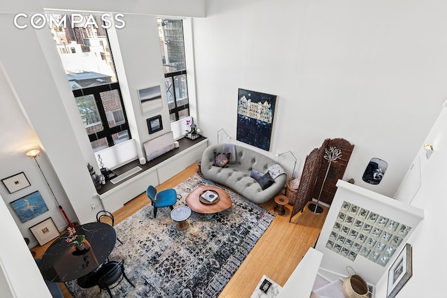 135 W 70th St Unit 8A, New York City, NY 10023 - living area featuring wood finished floors and a towering ceiling