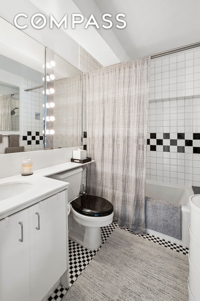 135 W 70th St Unit 8A, New York City, NY 10023 - full bathroom with toilet, vanity, tiled shower / bath, tile walls, and tile patterned flooring