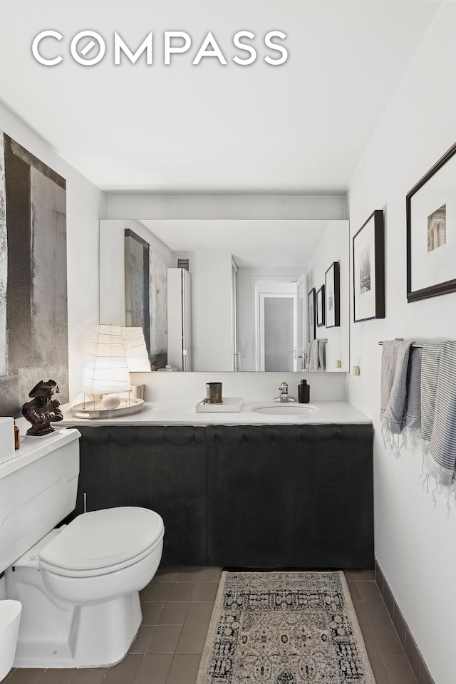 135 W 70th St Unit 8A, New York City, NY 10023 - bathroom with tile patterned floors, toilet, and vanity