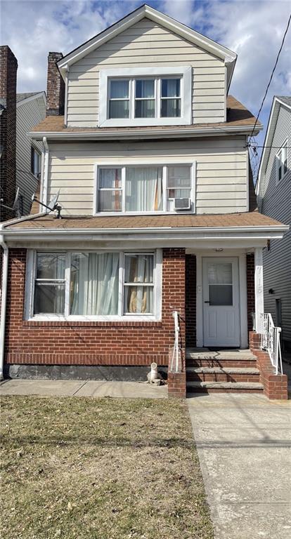 view of front of house with brick siding