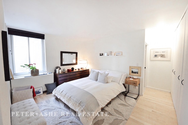 bedroom featuring light wood-type flooring and baseboards