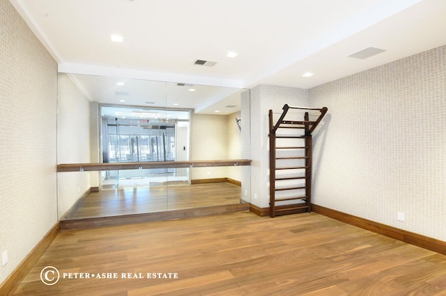 interior space with wallpapered walls and baseboards