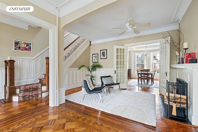 434 74th St, New York City, NY 11209 - living area with stairs, ceiling fan, a decorative wall, ornamental molding, and a chandelier