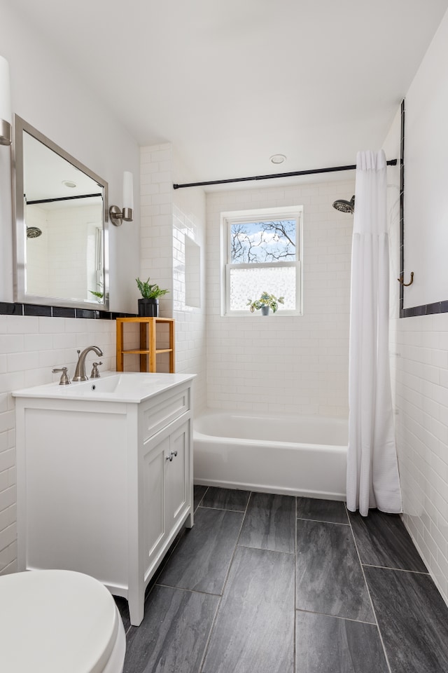 253 21st St, New York City, NY 11215 - bathroom featuring shower / tub combo, tile walls, vanity, and toilet
