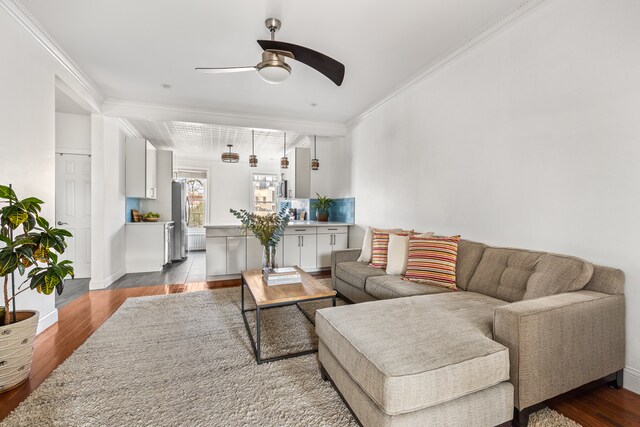 253 21st St, New York City, NY 11215 - living room featuring ceiling fan, wood finished floors, and ornamental molding