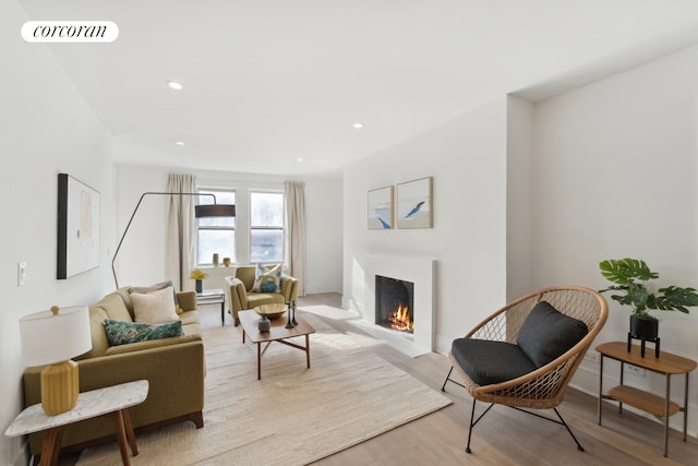 148-09 Northern Blvd Unit 6L, New York City, NY 11354 - living area featuring wood finished floors, a lit fireplace, and recessed lighting