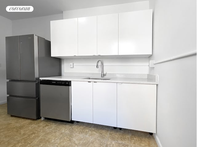 148-09 Northern Blvd Unit 6L, New York City, NY 11354 - kitchen featuring appliances with stainless steel finishes, light countertops, a sink, white cabinets, and baseboards
