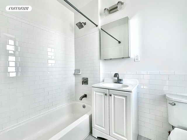 148-09 Northern Blvd Unit 6L, New York City, NY 11354 - full bath with tile walls, vanity, shower / bathtub combination, and wainscoting